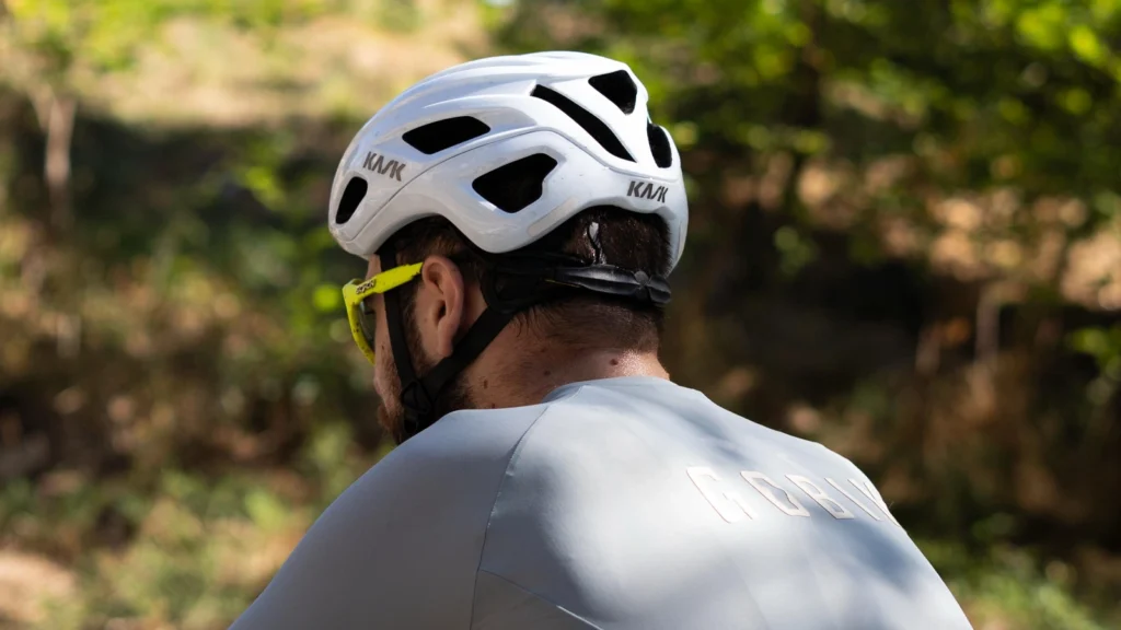 Vista trasera de ciclista con casco Kask Mojito blanco en movimiento