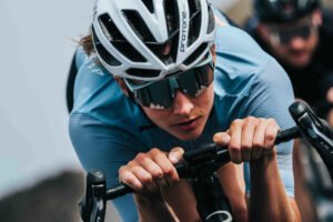 Ciclista con gafas KOO Alibi fotocromáticas pedaleando en posición aerodinámica.